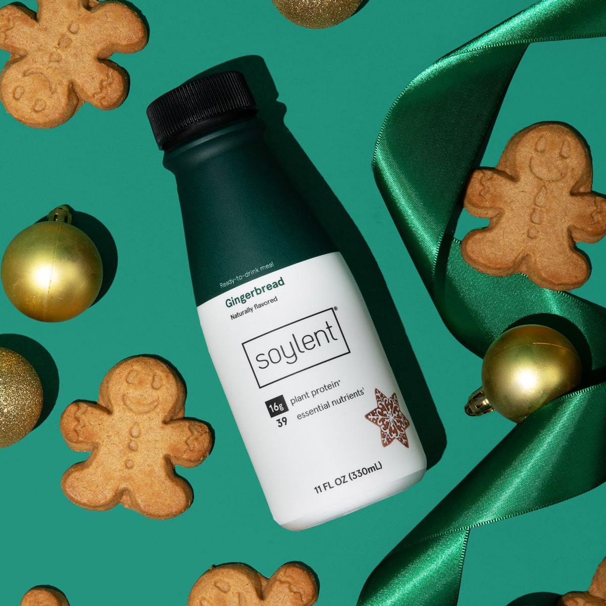 Soylent gingerbread flavored complete meal drink next to gingerbread cookies.